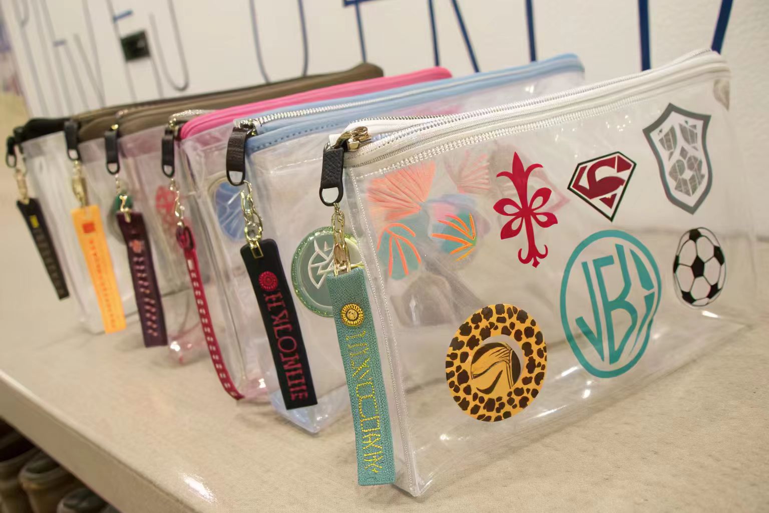 A close-up of three bags, each showing a different printing technique: screen print, UV print, and embossing.