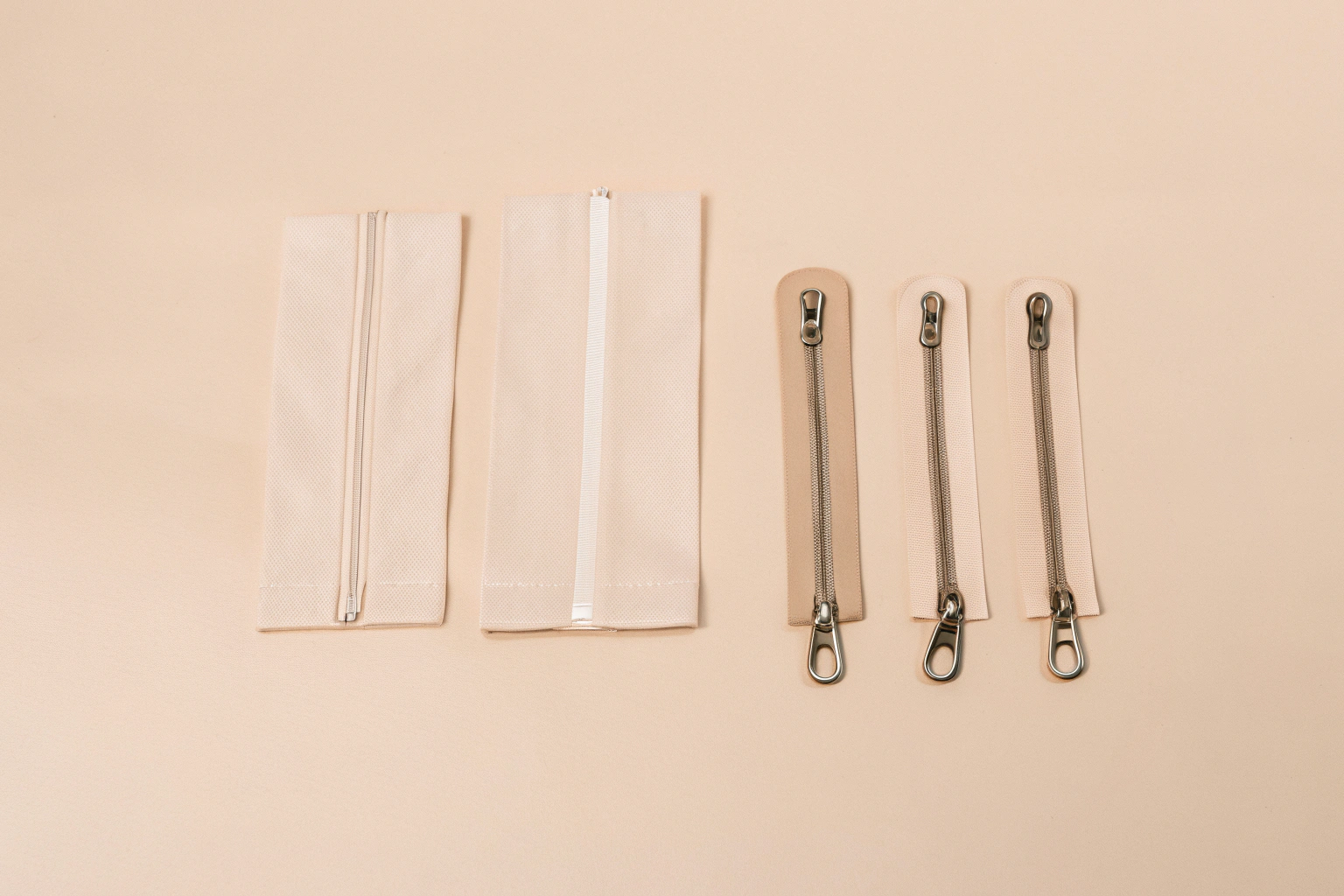 Selecting Materials and Hardware for Makeup Bags A flat lay of various material swatches like rPET and vegan leather, alongside different metal zippers and custom pulls