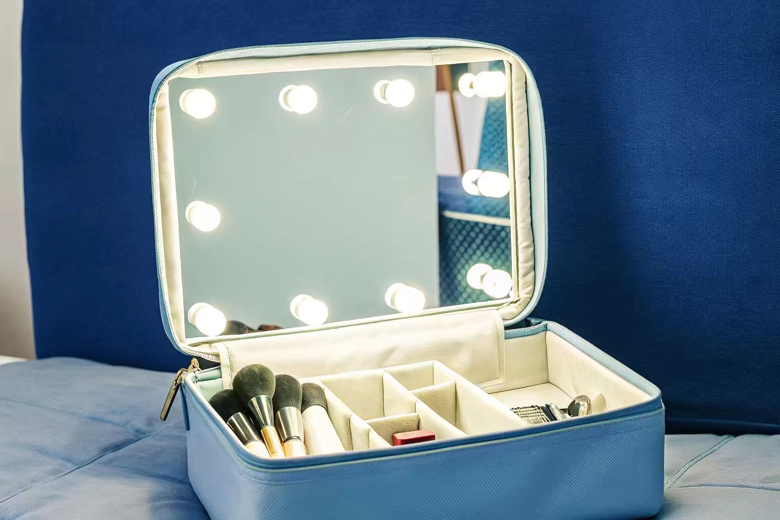 A makeup bag open to show a custom interior with LED lights and special compartments